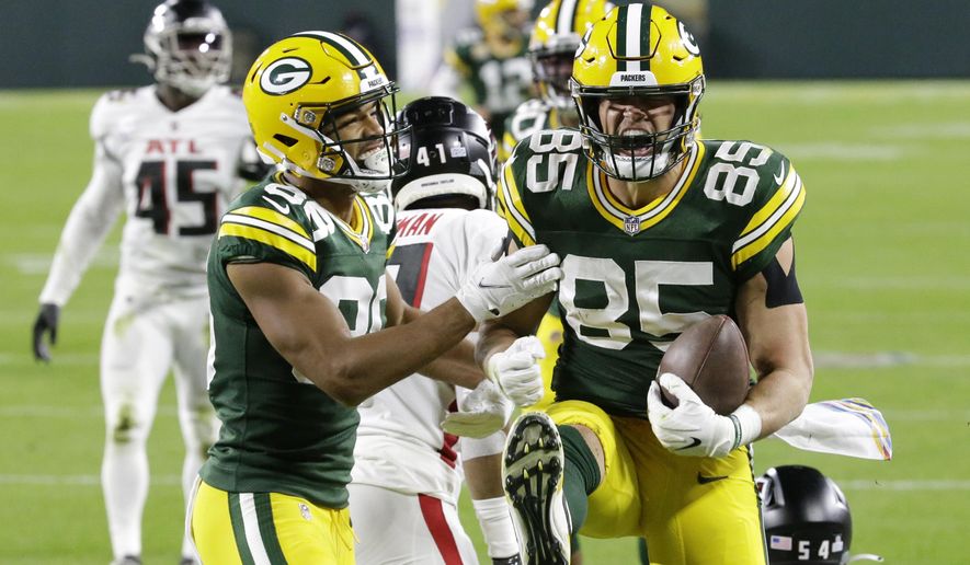 Green Bay Packers&#39; Robert Tonyan (85) celebrates a touchdown reception with Malik Taylor (86) during the first half of an NFL football game against the Atlanta Falcons, Monday, Oct. 5, 2020, in Green Bay, Wis. (AP Photo/Mike Roemer)