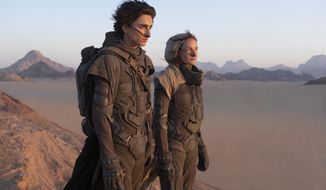 This image released by Warner Bros. Entertainment shows Timothee Chalamet, left, and Rebecca Ferguson in a scene from &amp;quot;Dune.&amp;quot; Warner Bros. said late Monday that its sci-fi pic “Dune” will now open in October 2021, instead of this December. The studio also pushed back it’s “Matrix” sequel by 8 months to late 2021 and “The Batman” to 2022. (Chia Bella James/Warner Bros. Entertainment via AP)