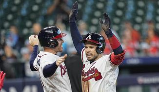 Atlanta Braves&#x27; Travis d&#x27;Arnaud, right, celebrates with teammate Freddie Freeman after hitting a three-run home run during the seventh inning in Game 1 of a baseball National League Division Series against the Miami Marlins Tuesday, Oct. 6, 2020, in Houston. (AP Photo/Eric Gay)