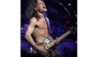 FILE - In this Aug. 5, 2004 file photo, Van Halen guitarist Eddie Van Halen performs in Phoenix. Van Halen, who had battled mouth cancer, died Tuesday, Oct. 6, 2020. He was 65. (AP Photo/Tom Hood, File)