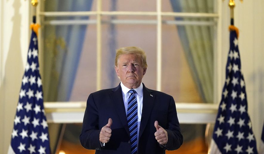 President Donald Trump stands on the balcony outside of the Blue Room as returns to the White House Monday, Oct. 5, 2020, in Washington, after leaving Walter Reed National Military Medical Center, in Bethesda, Md. Trump announced he tested positive for COVID-19 on Oct. 2. (AP Photo/Alex Brandon) **FILE**
