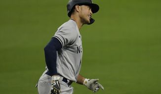 New York Yankees&#39; Giancarlo Stanton rounds the bases after he hit a three-run home run to score Luke Voit and Aaron Hicks during the fourth inning in Game 2 of a baseball American League Division Series against the Tampa Bay Rays, Tuesday, Oct. 6, 2020, in San Diego. (AP Photo/Gregory Bull)