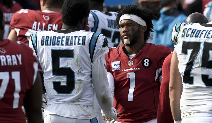 Carolina Panthers quarterback Teddy Bridgewater, left, and Arizona Cardinals quarterback Kyler Murray meet on the field after an NFL football game Sunday, Oct. 4, 2020, in Charlotte, N.C. (AP Photo/Mike McCarn)