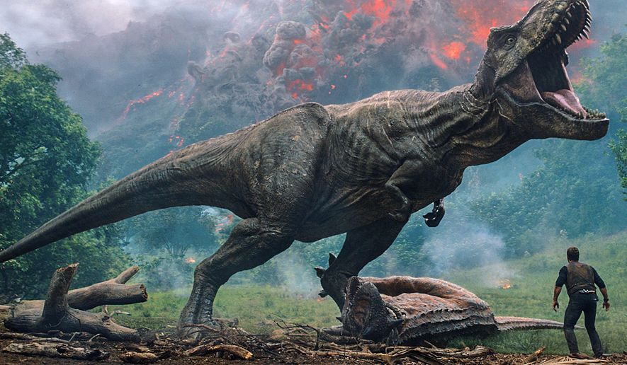 This image released by Universal Pictures shows a scene from the upcoming &amp;quot;Jurassic World: Fallen Kingdom.&amp;quot; Filming on the new “Jurassic World: Dominion” movie has been suspended for two weeks in the U.K. because of COVID-19 cases on set. Director Colin Trevorrow tweeted Wednesday that there were “a few” positive tests for the virus.  (Universal Pictures via AP)