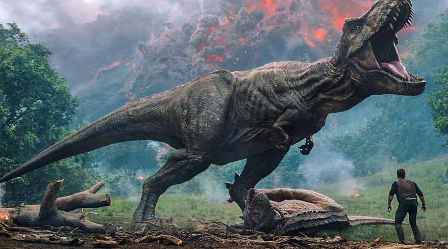 This image released by Universal Pictures shows a scene from the upcoming "Jurassic World: Fallen Kingdom." Filming on the new “Jurassic World: Dominion” movie has been suspended for two weeks in the U.K. because of COVID-19 cases on set. Director Colin Trevorrow tweeted Wednesday that there were “a few” positive tests for the virus. (Universal Pictures via AP)
