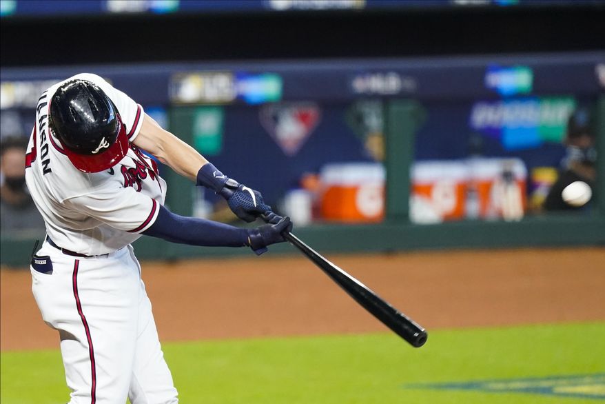 Atlanta Braves' Dansby Swanson hits a home run during the second inning in Game 2 of a baseball National League Division Series against the Miami Marlins Wednesday, Oct. 7, 2020, in Houston. (AP Photo/Eric Gay)