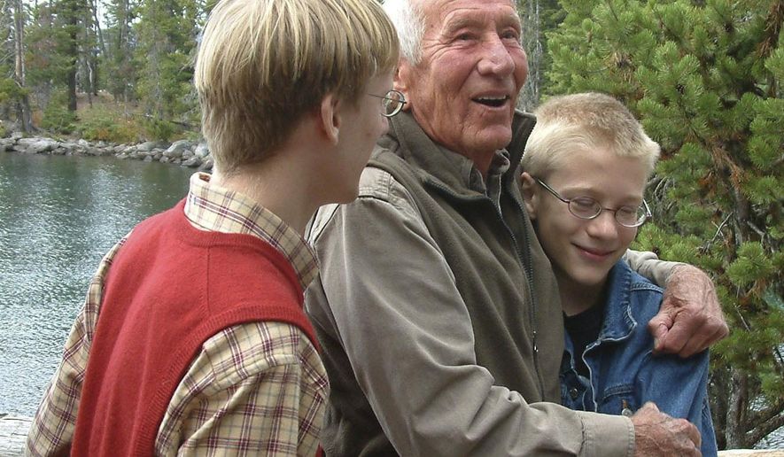 In this 2008 file photo, former congressman Jim Weaver and his grandsons, James Heun-Weaver, 16, left, and Julian Heun-Weaver, 12, stand at Waldo Lake after a ceremony to officially dedicate the Jim Weaver loop around the lake, near Oakridge, Ore. Weaver, a former Democratic congressman for Oregon’s 4th District who was a tireless advocate for environmental preservation, has died after a life dedicated to Oregon politics.Weaver at age 93 died early Tuesday morning, Oct. 6, 2020, and had been in a care facility for some time, The Register-Guard reported Wednesday. (Susan Palmer/The Register-Guard via AP)