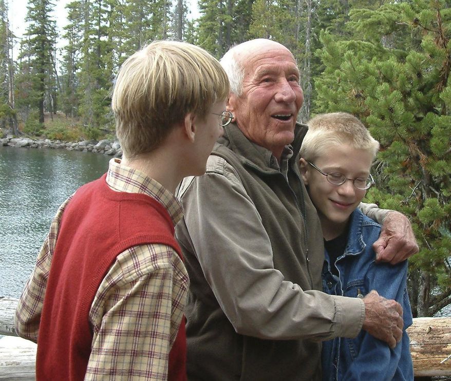 In this 2008 file photo, former congressman Jim Weaver and his grandsons, James Heun-Weaver, 16, left, and Julian Heun-Weaver, 12, stand at Waldo Lake after a ceremony to officially dedicate the Jim Weaver loop around the lake, near Oakridge, Ore. Weaver, a former Democratic congressman for Oregon’s 4th District who was a tireless advocate for environmental preservation, has died after a life dedicated to Oregon politics.Weaver at age 93 died early Tuesday morning, Oct. 6, 2020, and had been in a care facility for some time, The Register-Guard reported Wednesday. (Susan Palmer/The Register-Guard via AP)