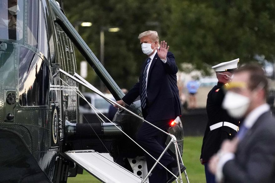 FILE - In this Oct. 5, 2020, file photo, President Donald Trump boards Marine One at Walter Reed National Military Medical Center after receiving treatment for coronavirus in Bethesda, Md. Ethics experts say the special treatment Trump received to access an experimental COVID-19 drug raises fairness issues and the public&#x27;s right to know more about Trump&#x27;s condition. (AP Photo/Evan Vucci, File)