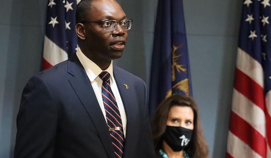 FILE - In this Sept. 10, 2020, file photo, provided by the Michigan Office of the Governor, Michigan Lt. Gov. Garlin Gilchrist II, accompanied by Gov. Gretchen Whitmer, right, speaks during an address to the state in Lansing, Mich. Lt. Gov. Gilchrist is calling for Republican legislative leaders to enact and enforce a mask requirement inside the House and Senate chambers. He said Wednesday, Oct. 7, 2020, he fears for the safety of his family and others when lawmakers do not wear a face covering. The Democrat presides over session in the Senate, which will return Thursday to start passing bills following a Michigan Supreme Court ruling that invalidated Gov. Gretchen Whitmer's coronavirus orders. (Michigan Office of the Governor via AP File)