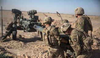 In this June 10, 2017, photo provided by Operation Resolute Support, U.S. soldiers with Task Force Iron maneuver an M-777 howitzer, so it can be towed into position at Bost Airfield, Afghanistan. (Associated Press) ** FILE **