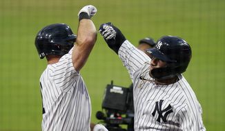 New York Yankees&#39; Gleyber Torres, right, celebrates with Brett Gardner, left, after Torres hit a two-run home run to score Gardner during the sixth inning in Game 4 of a baseball American League Division Series against the Tampa Bay Rays, Thursday, Oct. 8, 2020, in San Diego. (AP Photo/Gregory Bull)
