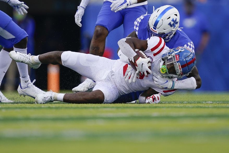 Kentucky linebacker Jamin Davis, top, tackles Mississippi wide receiver Demarcus Gregory (3) during the first half of an NCAA college football game, Saturday, Oct. 3, 2020, in Lexington, Ky. (AP Photo/Bryan Woolston)