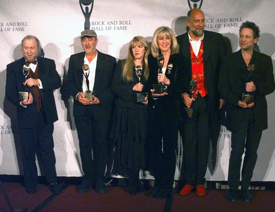 FILE - Members of Fleetwood Mac, from left, Peter Green; John McVie; Stevie Nicks; Christine McVie; Mick Fleetwood; and Lindsey Buckingham hold their awards after the group was inducted into the Rock and Roll Hall of Fame in New York on Jan. 12, 1998. Nicks has spent the last 10 months homebound, mainly due to the coronavirus pandemic. During that time, she recorded the new single “Show Them the Way,&amp;quot; releasing Friday and edited her new concert film “Stevie Nicks 24 Karat Gold The Concert,&amp;quot; available at select theaters and drive-ins on Oct. 21 and 25.  (AP Photo/Adam Nadel, File)