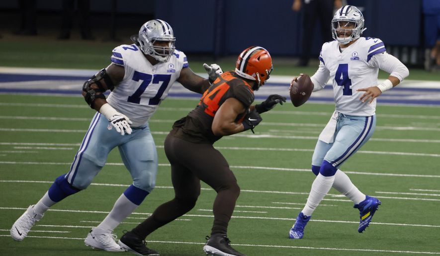 Dallas Cowboys offensive tackle Tyron Smith (77) defends against pressure from Cleveland Browns defensive end Olivier Vernon (54) as quarterback Dak Prescott (4) looks to make a pass in the first half of an NFL football game in Arlington, Texas, Sunday, Oct. 4, 2020. (AP Photo/Ron Jenkins)