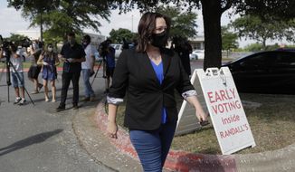 Democratic U.S. Senate candidate MJ Hegar heads to an early polling site after talking with the media, Thursday, July 9, 2020, in Austin, Texas. Hegar is in a runoff with State Sen. Royce West. (AP Photo/Eric Gay)