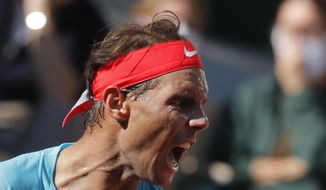 Spain&#39;s Rafael Nadal screams after scoring a point against Argentina&#39;s Diego Schwartzman in the semifinal match of the French Open tennis tournament at the Roland Garros stadium in Paris, France, Friday, Oct. 9, 2020. (AP Photo/Michel Euler)
