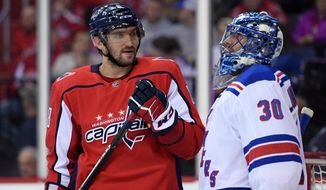 FILE - In this March 28, 2018, file photo, Washington Capitals left wing Alex Ovechkin (8), of Russia, with New York Rangers goaltender Henrik Lundqvist (30), of Sweden, during the second period of an NHL hockey game in Washington. Lundqvist signed with the Capitals when free agency opened Friday, Oct. 9, 2020. (AP Photo/Nick Wass, File)