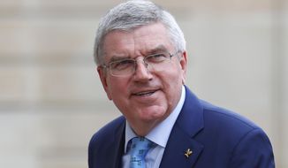FILE - In this June 7, 2019, file photo, International Olympic Committee (IOC) President Thomas Bach arrives to meet French President Emmanuel Macron at the Elysee Palace in Paris. Bach is planning a trip to Japan November, 2020, to meet with new Prime Minister Yoshihide Suga and organizers of the postponed Tokyo Olympics, Tokyo Olympic CEO Toshiro Muto said Friday, Oct. 9. (AP Photo/Francois Mori, File)