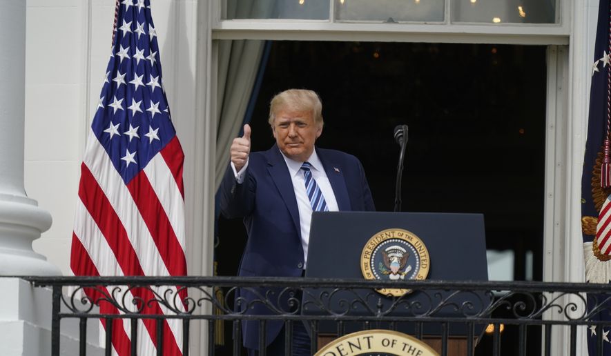 President Donald Trump gives a thumbs up from the Blue Room Balcony of the White House to a crowd of supporters, Saturday, Oct. 10, 2020, in Washington. (AP Photo/Alex Brandon)