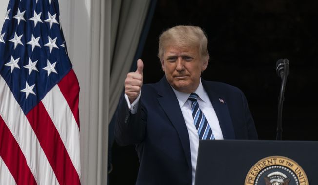 President Donald Trump gives thumbs up, as he departs after speaking from the Blue Room Balcony of the White House to a crowd of supporters, Saturday, Oct. 10, 2020, in Washington. (AP Photo/Alex Brandon)