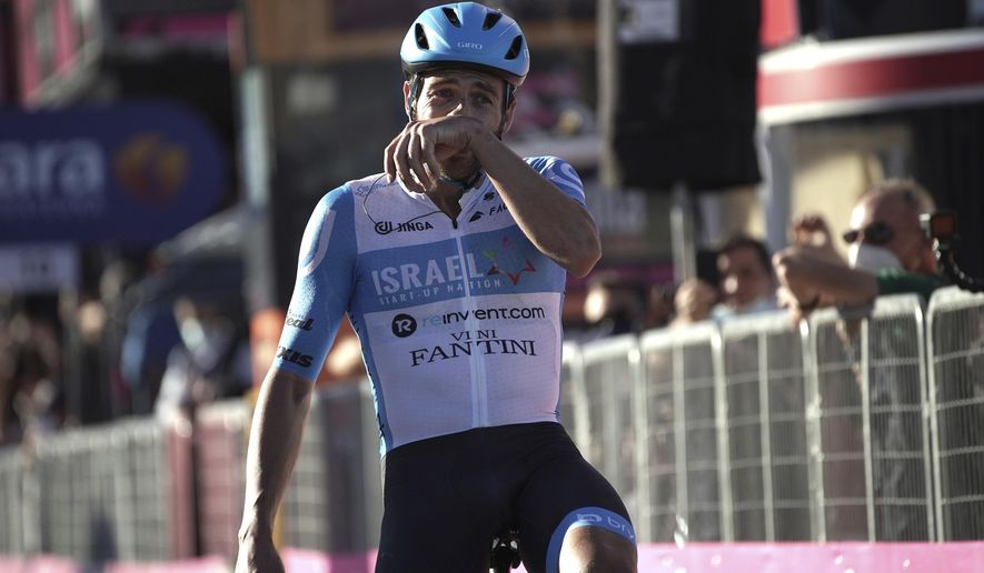 Alex Dowsett celebrates as he crosses the finish line to win the eight stage of the Giro d'Italia cycling race from Giovinazzo to Vieste, Italy, Saturday, Oct. 10, 2020. (Gian Mattia D'Alberto/LaPresse via AP)