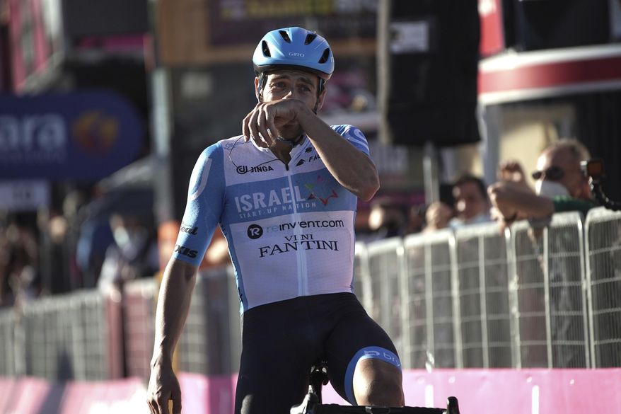 Alex Dowsett celebrates as he crosses the finish line to win the eight stage of the Giro d'Italia cycling race from Giovinazzo to Vieste, Italy, Saturday, Oct. 10, 2020. (Gian Mattia D'Alberto/LaPresse via AP)