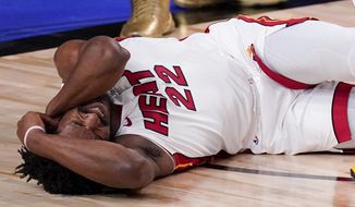Miami Heat forward Jimmy Butler grimaces after getting fouled during the second half in Game 5 of basketball&#39;s NBA Finals against the Los Angeles Lakers Friday, Oct. 9, 2020, in Lake Buena Vista, Fla. (AP Photo/Mark J. Terrill)