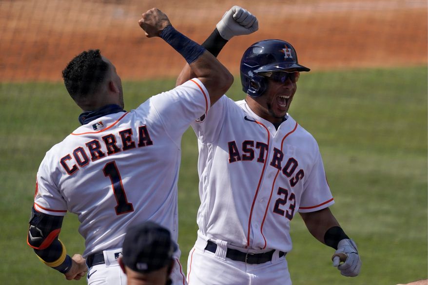 Michael Brantley and Carlos Correa have the Astros eight wins way from another World Series title after winning it in 2017. The Astros began the AL Championship Series against the Rays on Sunday night. (Associated Press)