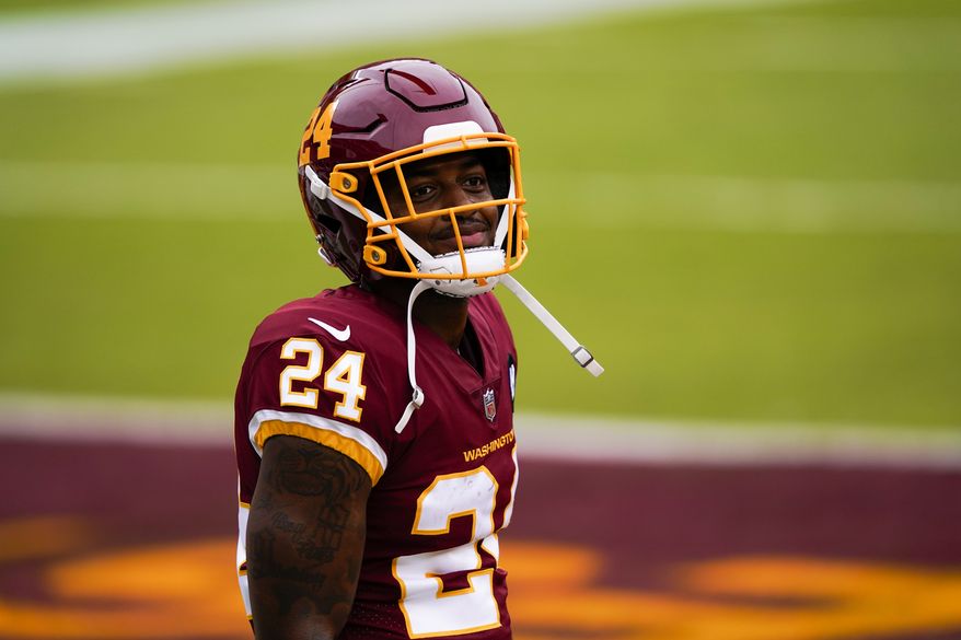 Washington Football Team's Antonio Gibson warms up before an NFL football game against the Los Angeles Rams Sunday, Oct. 11, 2020, in Landover, Md. (AP Photo/Susan Walsh)