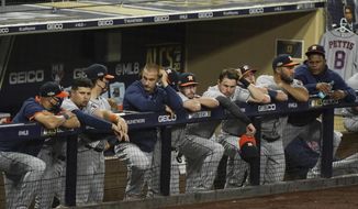 Houston Astros watch the seventh inning in Game 1 of a baseball American League Championship Series against the Tampa Bay Rays, Sunday, Oct. 11, 2020, in San Diego. (AP Photo/Ashley Landis)