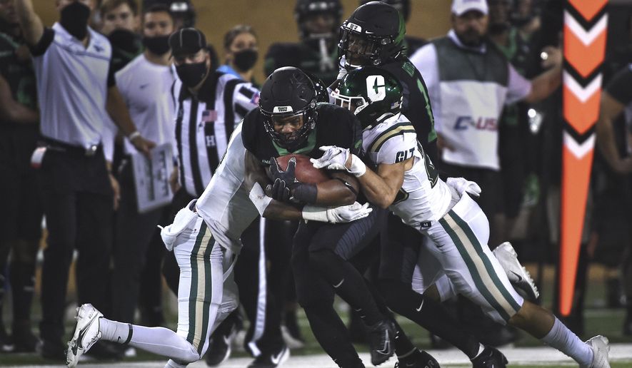 North Texas' DeAndre Torrey drags Charlotte defenders for a long gain during an NCAA college football game Saturday, Oct. 10, 2020, in Denton, Texas. (Al Key/The Denton Record-Chronicle via AP)