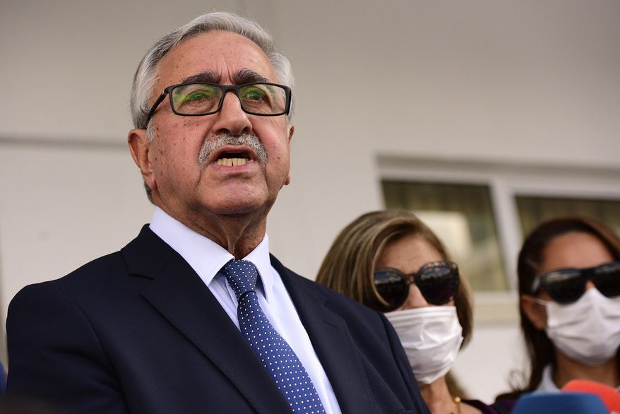 Turkish Cypriot leader and candidate Mustafa Akinci talks after casting his ballot at a polling station during the Turkish Cypriots election for a new leader in the Turkish occupied area in the north part of the divided capital Nicosia, Cyprus, Sunday, Oct. 11, 2020. Turkish Cypriots are voting for a leader tasked with overcoming deep political chasms with rival Greek Cypriots in order to pave the way for a deal to end 46 years of ethnic division in Cyprus and quell tensions over offshore energy reserves. (AP Photo/Nedim Enginsoy)