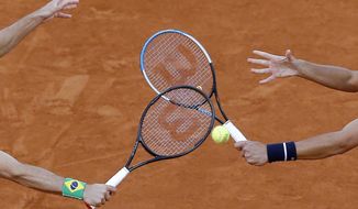 Croatia&#39;s Mate Pavic, right, and Brazil&#39;s Bruno Soares play a shot against Kevin Krawietz and Andreas Mies of Germany in the men&#39;s doubles final match of the French Open tennis tournament at the Roland Garros stadium in Paris, France, Saturday, Oct. 10, 2020. (AP Photo/Michel Euler)