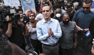 In this June 2, 2020, file photo, Los Angeles Mayor Eric Garcetti arrives to appeal to Black Lives Matter protesters in downtown Los Angeles. When Garcetti withdrew his support from District Attorney Jackie Lacey this week and endorsed her opponent, it was another blow to a campaign that has been reshaped after a summer of nationwide protests over police brutality. (AP Photo/Richard Vogel,File)