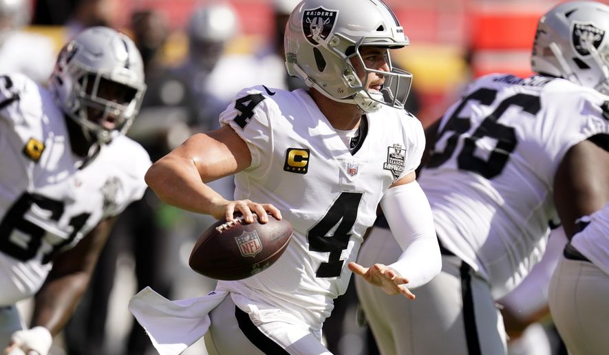 Las Vegas Raiders quarterback Derek Carr (4) looks to throw a pass during the first half of an NFL football game against the Kansas City Chiefs, Sunday, Oct. 11, 2020, in Kansas City. (AP Photo/Charlie Riedel)