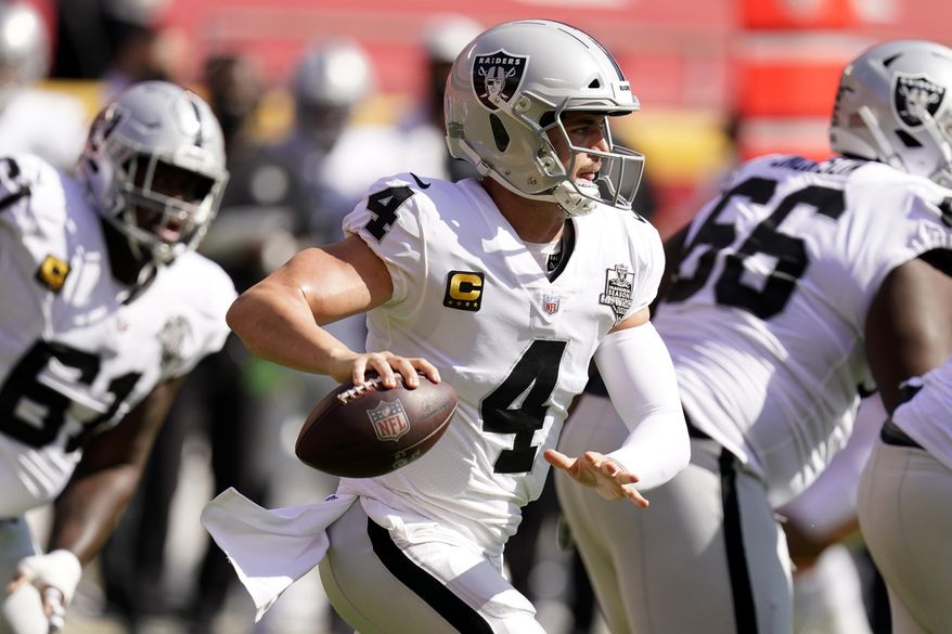 Las Vegas Raiders quarterback Derek Carr (4) looks to throw a pass during the first half of an NFL football game against the Kansas City Chiefs, Sunday, Oct. 11, 2020, in Kansas City. (AP Photo/Charlie Riedel)