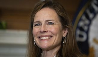 In this Oct. 1, 2020, photo, Supreme Court nominee Judge Amy Coney Barrett, meets with Sen. Roger Wicker, R-Miss., at the Capitol in Washington. Confirmation hearings begin Monday for President Donald Trump’s Supreme Court nominee, Amy Coney Barrett. If confirmed, the 48-year-old appeals court judge would fill the seat of liberal Justice Ruth Bader Ginsburg, who died last month.  (Graeme Jennings/Pool via AP)