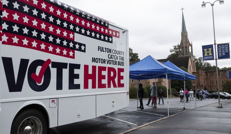 In this file photo, one of Fulton County&#x27;s two mobile voting stations sits in the parking lot of Morningside Baptist Church on Monday morning, Oct. 12, 2020, for the first day of early voting. (Ben Gray/Atlanta Journal-Constitution via AP)