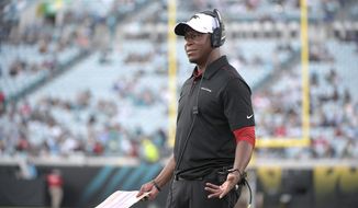 FILE - In this Aug. 19, 2019, file photo, Atlanta Falcons then-assistant head coach/passing game coordinator Raheem Morris watches from the sideline during the first half of a preseason NFL football game against the Jacksonville Jaguars, in Jacksonville, Fla. The Atlanta Falcons have named defensive coordinator Raheem Morris interim head coach after firing Dan Quinn.  (AP Photo/Phelan M. Ebenhack, File)