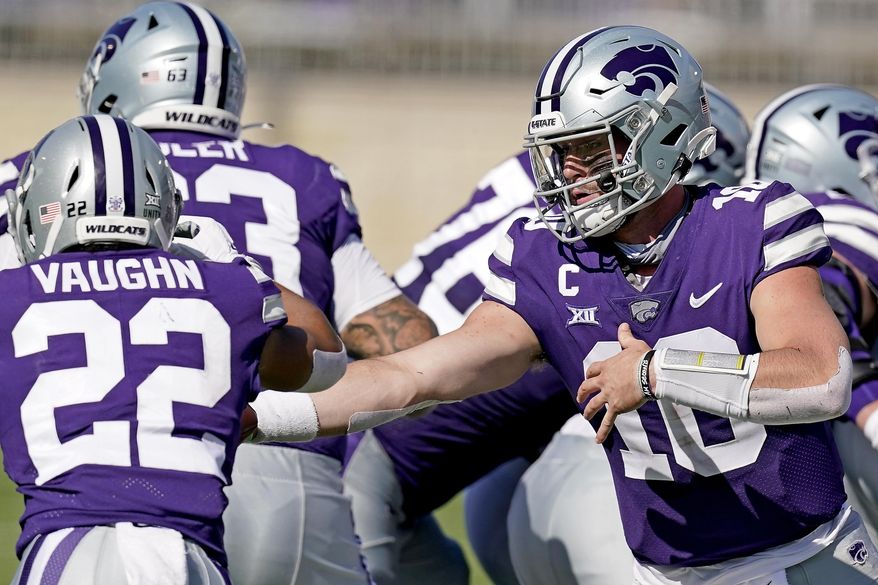 Kansas State quarterback Skylar Thompson (10) hands the ball to running back Deuce Vaughn (22) during the first half of an NCAA college football game against Texas Tech Saturday, Oct. 3, 2020, in Manhattan, Kan. (AP Photo/Charlie Riedel)
