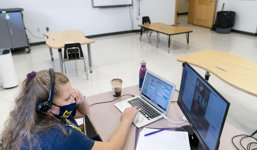 In this Friday, Sept. 18, 2020, photo fifth grade teacher Lauren Furst leads an online class at Meridien Public Charter School, in Washington. Several D.C. charter schools have been doing in-person teaching for small groups of students. (AP Photo/Andrew Harnik)  **FILE**
