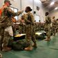In this image provided by the U.S. Army, recent Army basic combat training graduates have their temperatures taken as they arrive at Fort Lee, Va, on March 31, 2020, after being transported using sterilized buses from Fort Jackson, S.C. COVID-19 has had a dramatic impact on military recruiting, shuttering enlistment stations around the country and forcing thousands of recruiters to woo potential soldiers online. Recruiters have had to abandon their normal visits to high schools and malls, and instead rely almost exclusively on social media to reach young people. (U.S. Army via AP) **FILE**