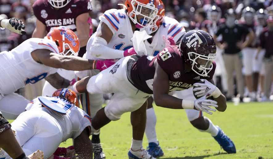 Texas A&M running back Isaiah Spiller (28) dives over the goal line for a touchdown against Florida during the second half of an NCAA college football game, Saturday, Oct. 10, 2020. in College Station, Texas. (AP Photo/Sam Craft)