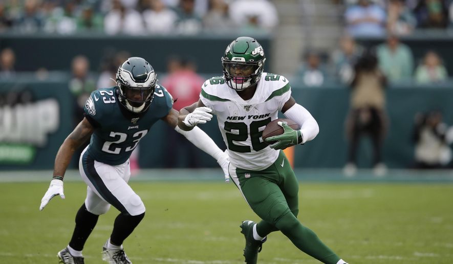 This Oct. 6, 2019, file photo shows New York Jets&#39; Le&#39;Veon Bell, right, rushing past Philadelphia Eagles&#39; Rodney McLeod during the first half of an NFL football game in Philadelphia. The New York Jets have surprisingly released Bell, ending a disappointing tenure after less than two full seasons. The team issued a statement from general manager Joe Douglas on Tuesday, Oct. 13, 2020, in which he says the Jets made the move after having several conversations with Bell and his agent during the last few days and exploring trade options. (AP Photo/Matt Rourke, File)  **FILE**