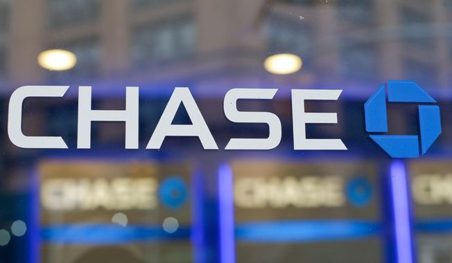 FILE - This Sept. 13, 2014, file photo, shows the Chase bank logo in New York. JPMorgan Chase says profits improved marginally in the third quarter, a notable change after the nation’s largest bank had to set aside billions in the last two quarters to cover losses from the coronavirus pandemic. The New York-based bank said it earned a profit of $9.44 billion, or $2.92 a share, in the July to September period.  (AP Photo/Frank Franklin II, File)
