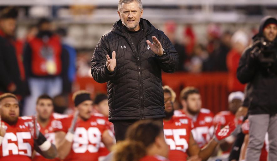 FILE - In this Nov. 30, 2019, file photo, Utah head coach Kyle Whittingham looks on before the start of their NCAA college football game against Colorado in Salt Lake City. The return of football isn't likely to make much of a dent in the losses athletic departments across the Pac-12 will ultimately incur because of the coronavirus pandemic. Faced with dramatic budget shortfalls, most schools in the league have already resorted to layoffs, furloughs, and cutting some sports entirely. At Utah, football coach Kyle Whittingham and men's basketball coach Larry Krystkowiak both took salary cuts to help offset up to $60 million in projected losses. (AP Photo/Rick Bowmer, File)