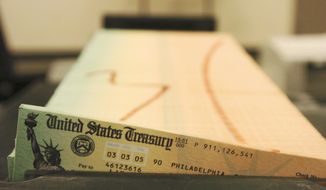 In this Feb. 11, 2005, photo, trays of printed social security checks wait to be mailed from the U.S. Treasury&#39;s Financial Management services facility in Philadelphia. (AP Photo/Bradley C. Bower) **FILE**