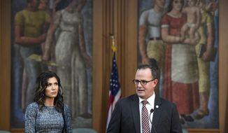 South Dakota Governor Kristi Noem, left, and  Public Safety Secretary Craig Price, right, speak during an update on the investigation of the Saturday, Sept. 12 crash involving Attorney General Jason Ravnsborg, Tuesday, Oct. 13, 2020, in Sioux Falls, SD.  (Erin Bormett/The Argus Leader via AP)
