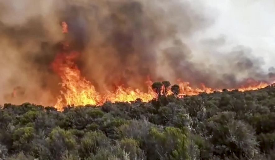 In this image made from video, fires burn on Mount Kilimanjaro in Tanzania on Monday, Oct. 12, 2020. Tanzanian authorities say 500 volunteers have been trying to put out a fire on Africa's tallest peak, Mt. Kilimanjaro. (AP Photo)